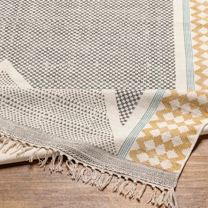 ブラック、マスタード、ティールカラーのこなれた配色と幾何学的パターン、ナチュラルモダンなデザインがオシャレなランナータイプのコットン製ハンドメイドラグラグの素材感がわかるクロースアップ