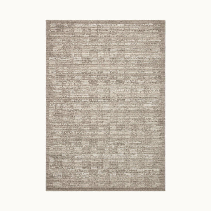 ダイニングテーブル下にも敷ける大きめサイズ（200*300cm）のニュートラルなストーンベージュカラーのグラデーションと立体的なリブのテクスチャーが絶妙な存在感を放つシンプルモダンラグ